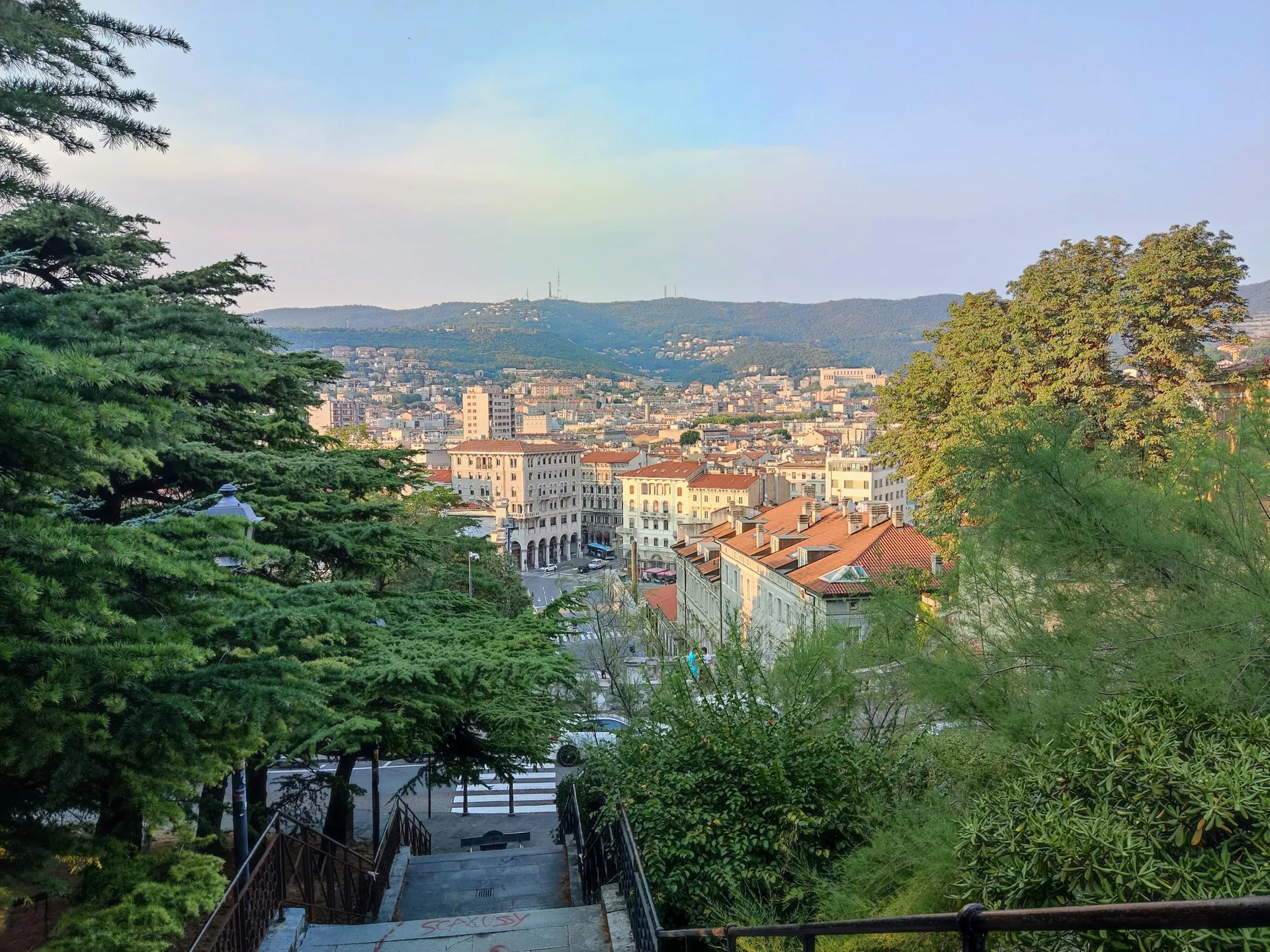 Beautiful view of Trieste with historical buildings and green surroundings.
