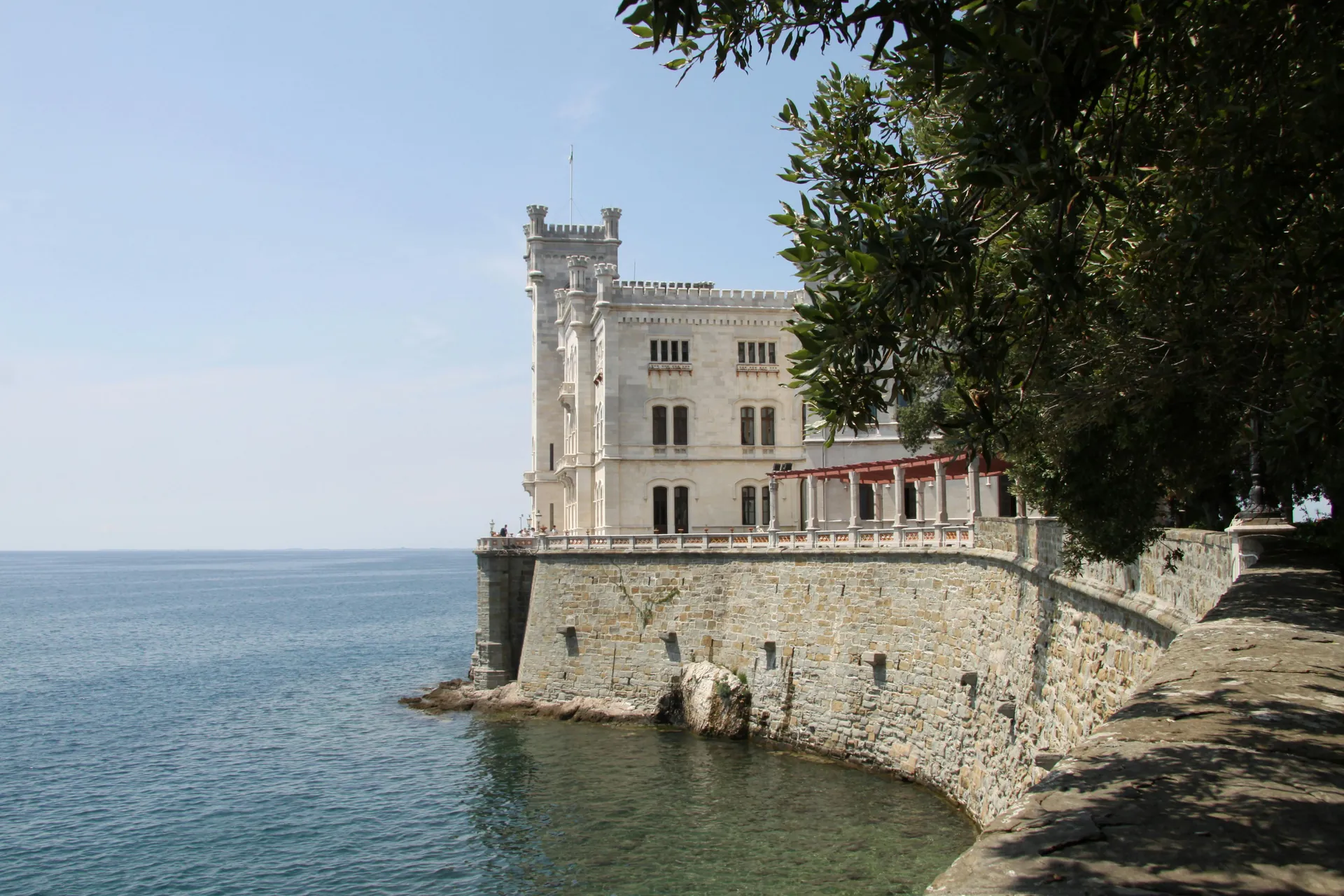 A stunning view of a historic seaside castle against a clear blue sky, ideal for architecture and travel imagery.